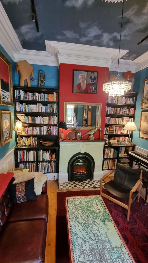 Living room with books, piano
